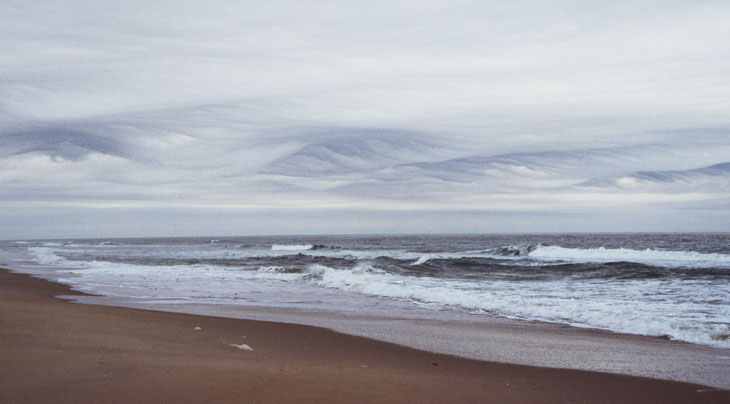 wave clouds over breakers on shoreline