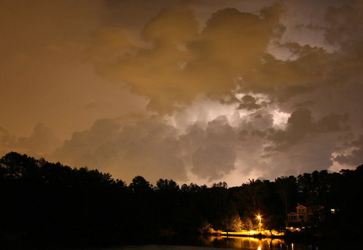 clouds lit by electrical storm and city lights