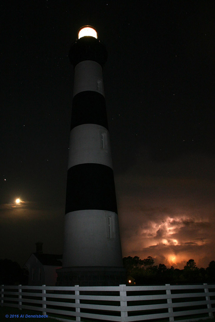 electrical storm and crescent moon behind Bodie Island lighthouse, NC - composite photo