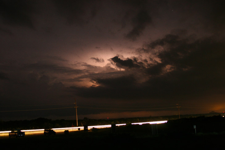 wide-sky night exposure illuminated twice by lightning, showing cloud movement