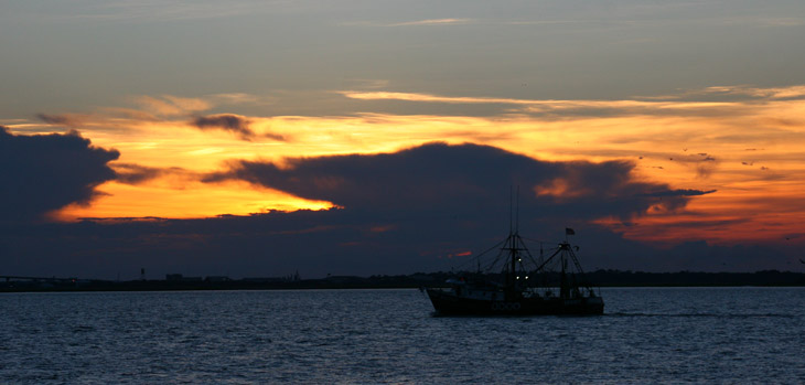 fishing boat against obscured sunset