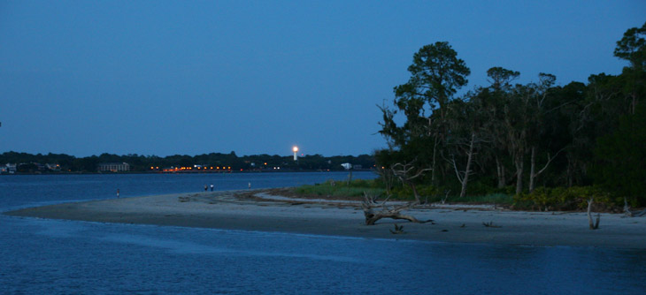 Driftwood Beach Jekyll Island at dusk with St Simon's Island light in background