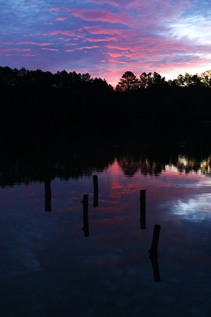 sunrise colors under clouds with faint sun pillar