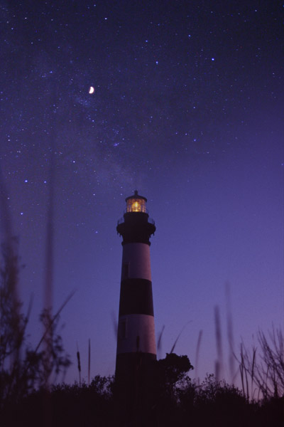 Bodie Island lighthouse against impossible starfield and Milky Way