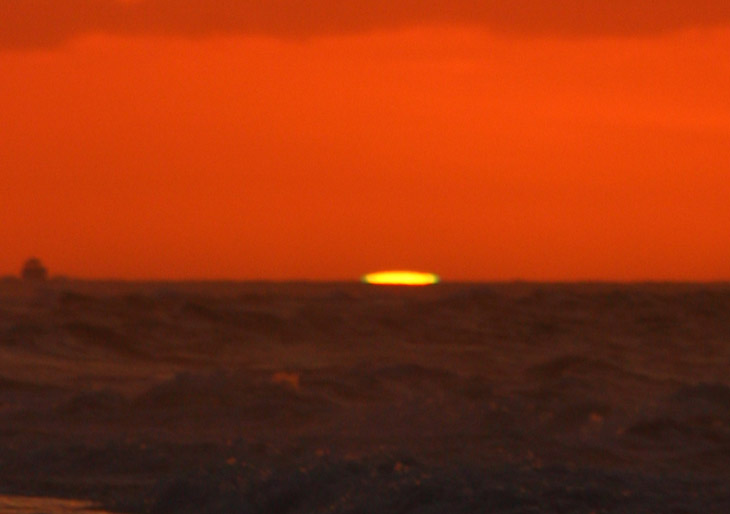 slightly out-of-focus sunrise showing distinct green edging