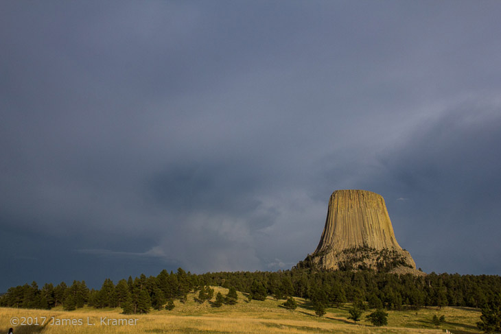 wide shot of Devil's Tower, Wyoming with storm in background by James L. Kramer