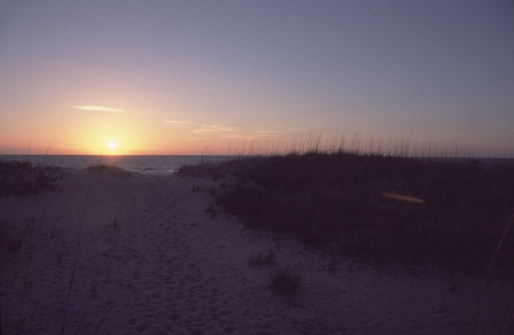 beach sunrise shot with flare from bright sun