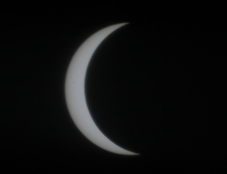 partial solar eclipse showing sunspots