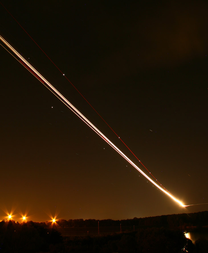 long exposure at night of landing jetliner