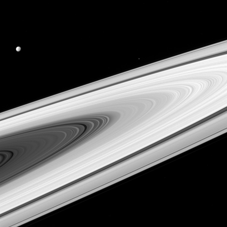 unidentified moon over Saturn's rings