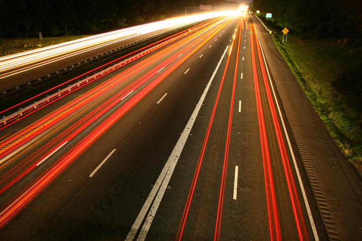 long night exposures of light trails on merging interstate highways