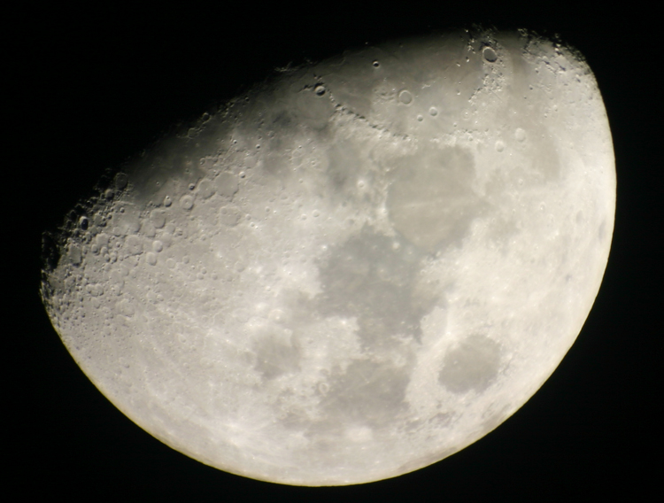 first quarter moon showing sunrise on Tycho's central peak