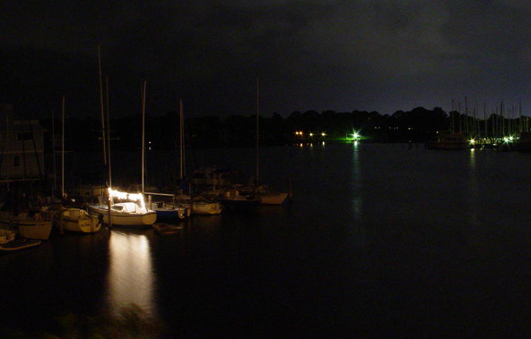 party lights on sailboat in marina at night