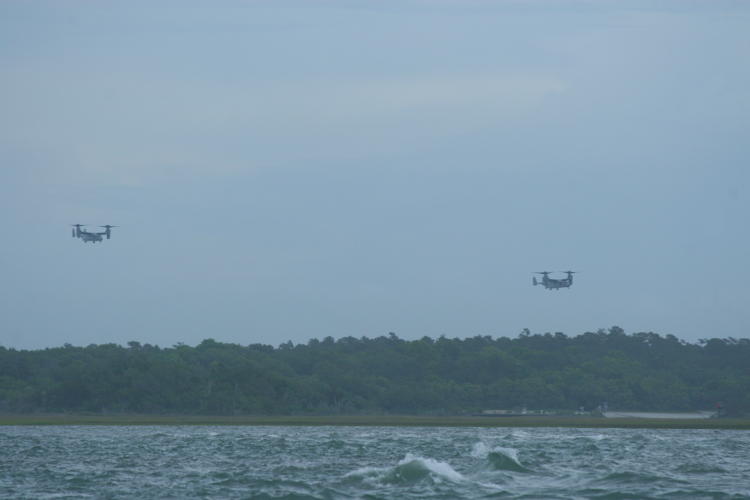 pair of V-22 Osprey on final approach over hidden airstrip