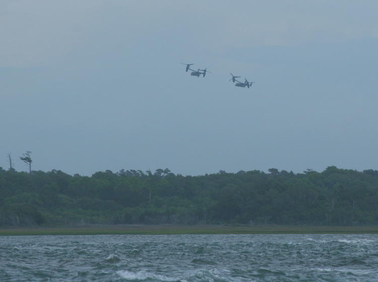 pair of V-22 Ospreys approaching landing zone