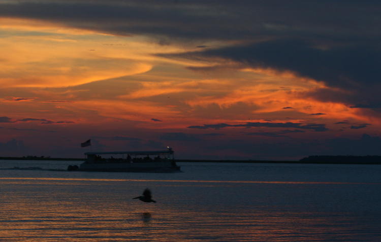 dolphin tour boat against dramatic sky, Jekyll Island Georgia