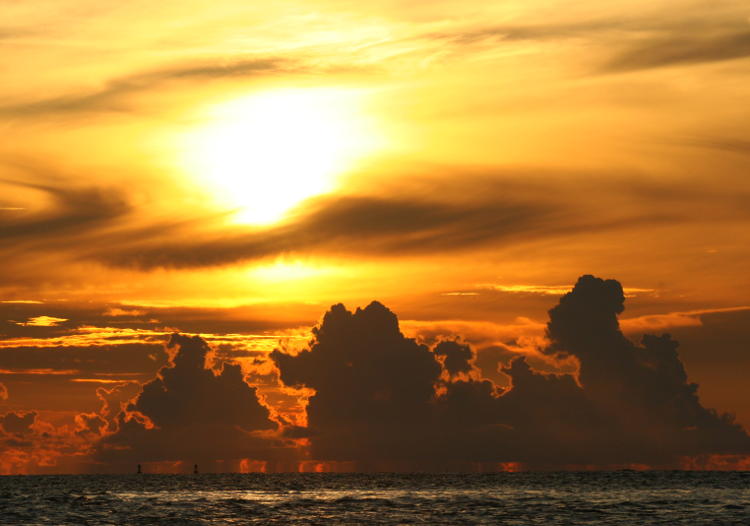 sunrise clouds off Jekyll Island showing distant rain storms