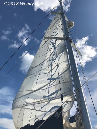 mainsail against sky, by Wendy Hall