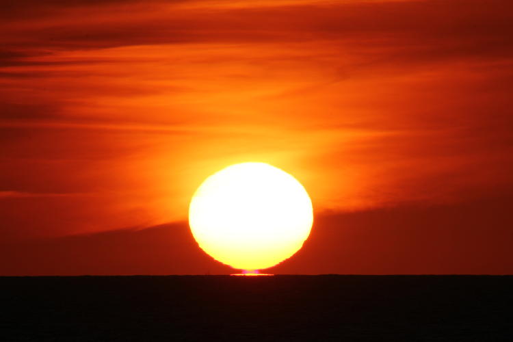 same sunrise showing red effect underneath sun