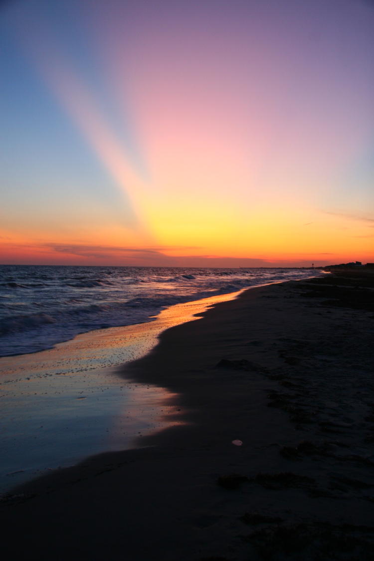 crepuscular rays at sunset on beach, Oak Island NC