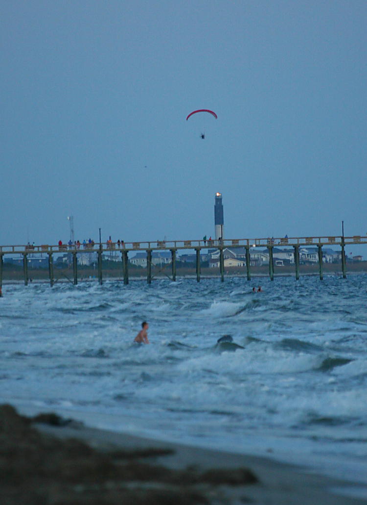 paraglider near Oak Island lighthouse at dusk