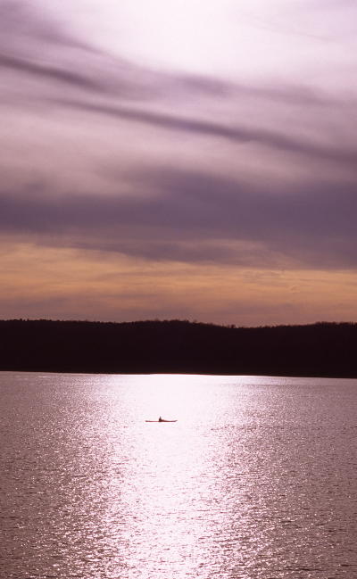 kayaker on Jordan Lake against sullen sky