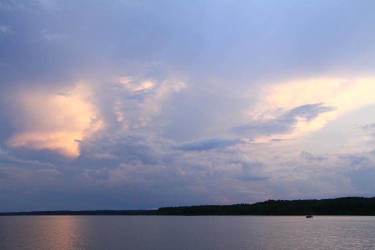 sunglow behind varied clouds at Jordan Lake