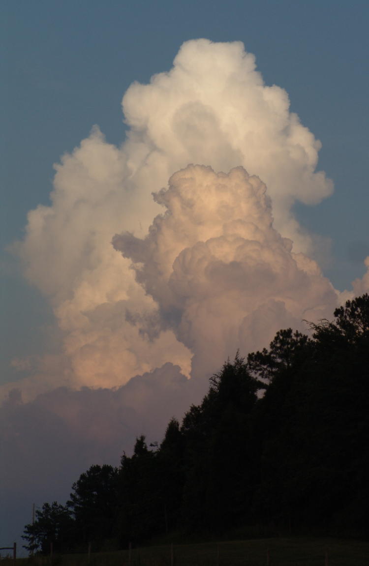 thunderheads illuminated by setting sun