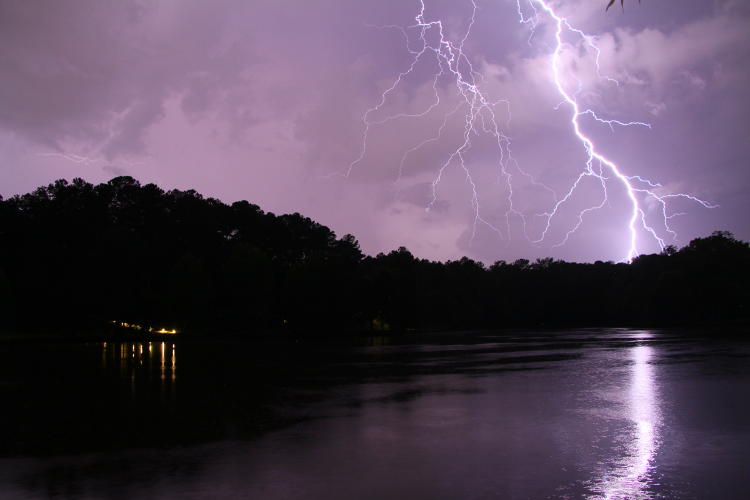 brilliant high lightning strike over pond