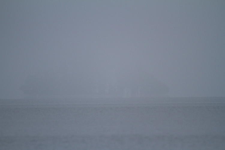 distant shadow through fog over Jordan Lake