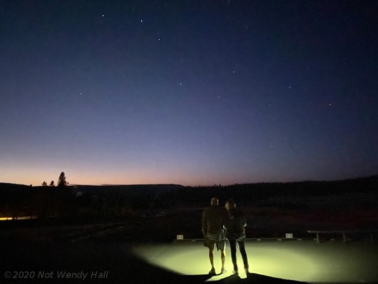 hikers at night against Big Dipper at Yellowstone National Park, by not Wendy Hall