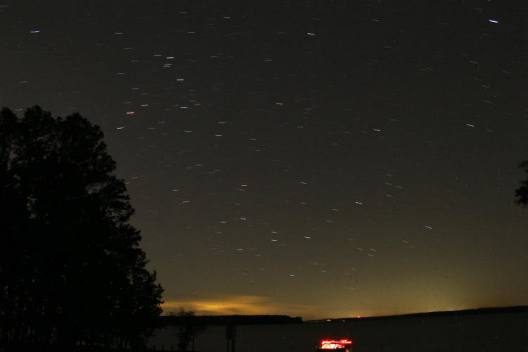 long night exposure over Jordan Lake showing kayaker preparing