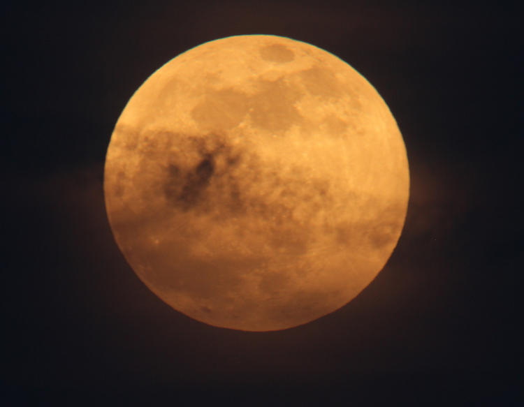 gold moon with thin cloudy accents