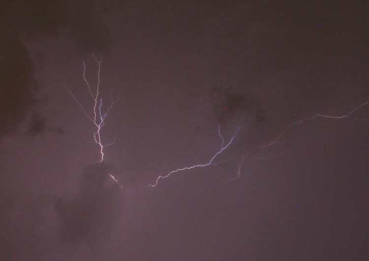 lightning fork almost obscured within clouds