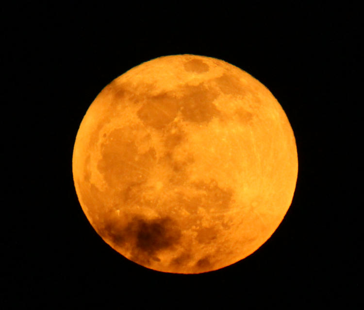 super gold rising full moon with hint of clouds