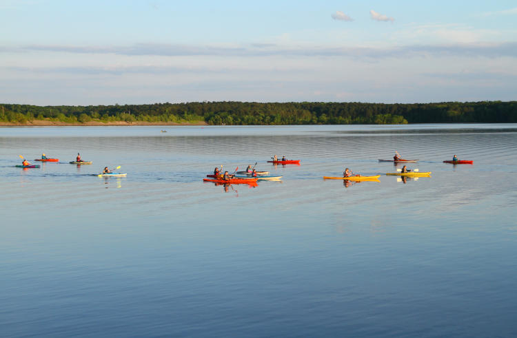 group of kayakers heading out for sunset tour
