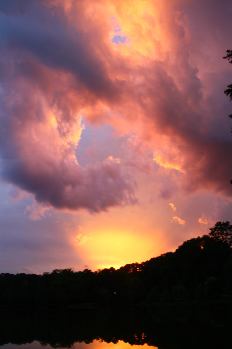 stormy sunset colors over pond