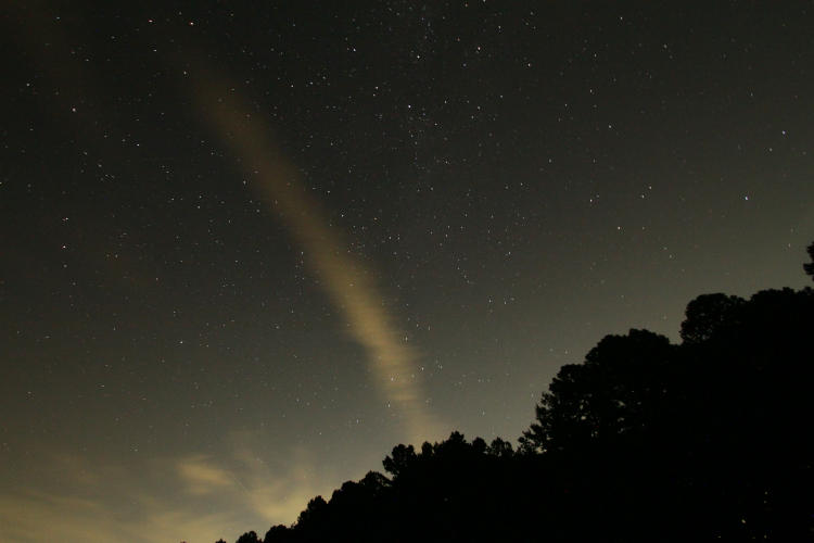 night exposure showing faint cloud or contrail and tiny hint of meteor or firefly