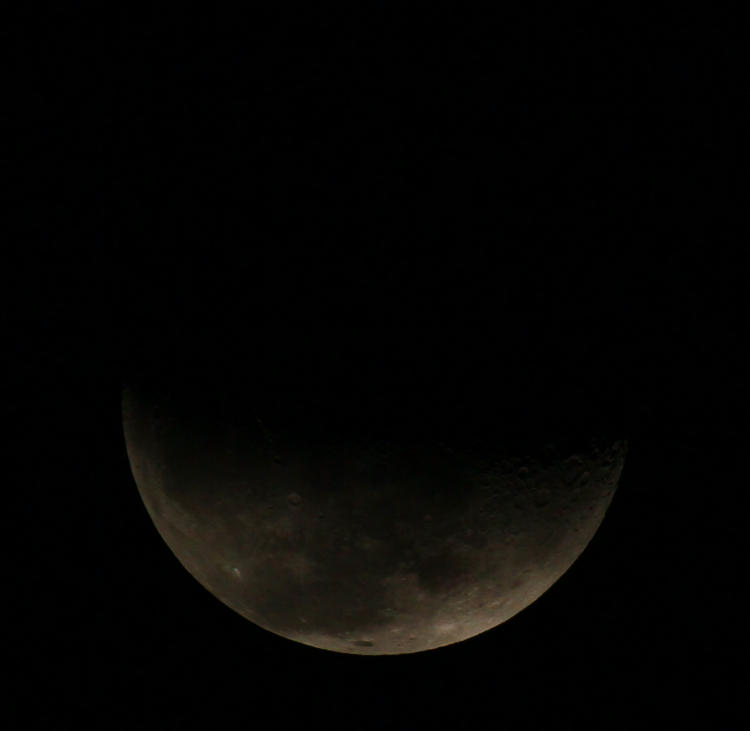 clouds beginning to obscure waning crescent moon