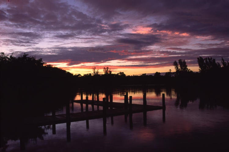 moody sunset skies over dock on Imperial River, Bonita Springs, Florida