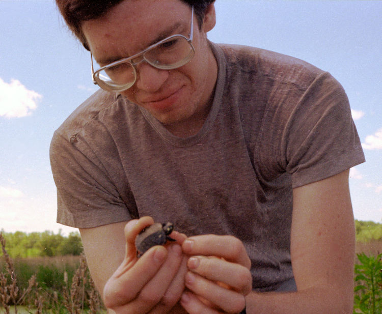 the author in his even-uglier phase holding a newborn turtle