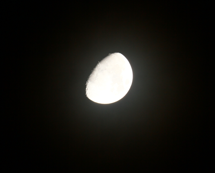 high-altitude haze around waxing gibbous moon on December solstice