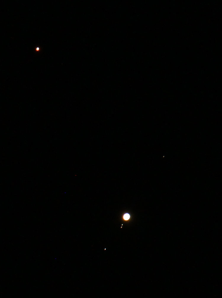 Mars and Jupiter in close conjunction, showing the four Jovian moons