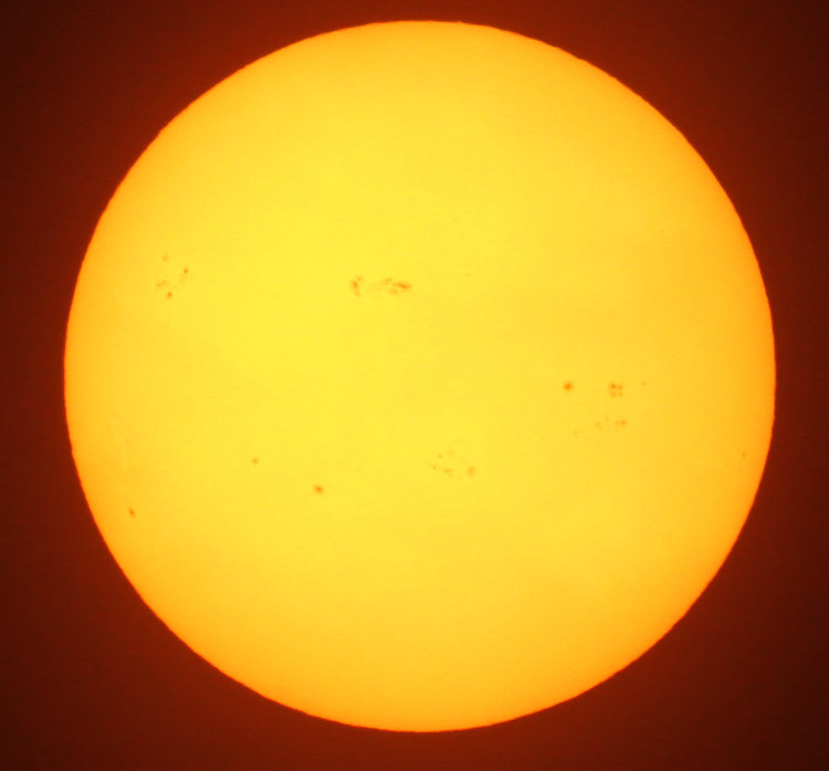 sunspots on sun's surface photographed with solar filter