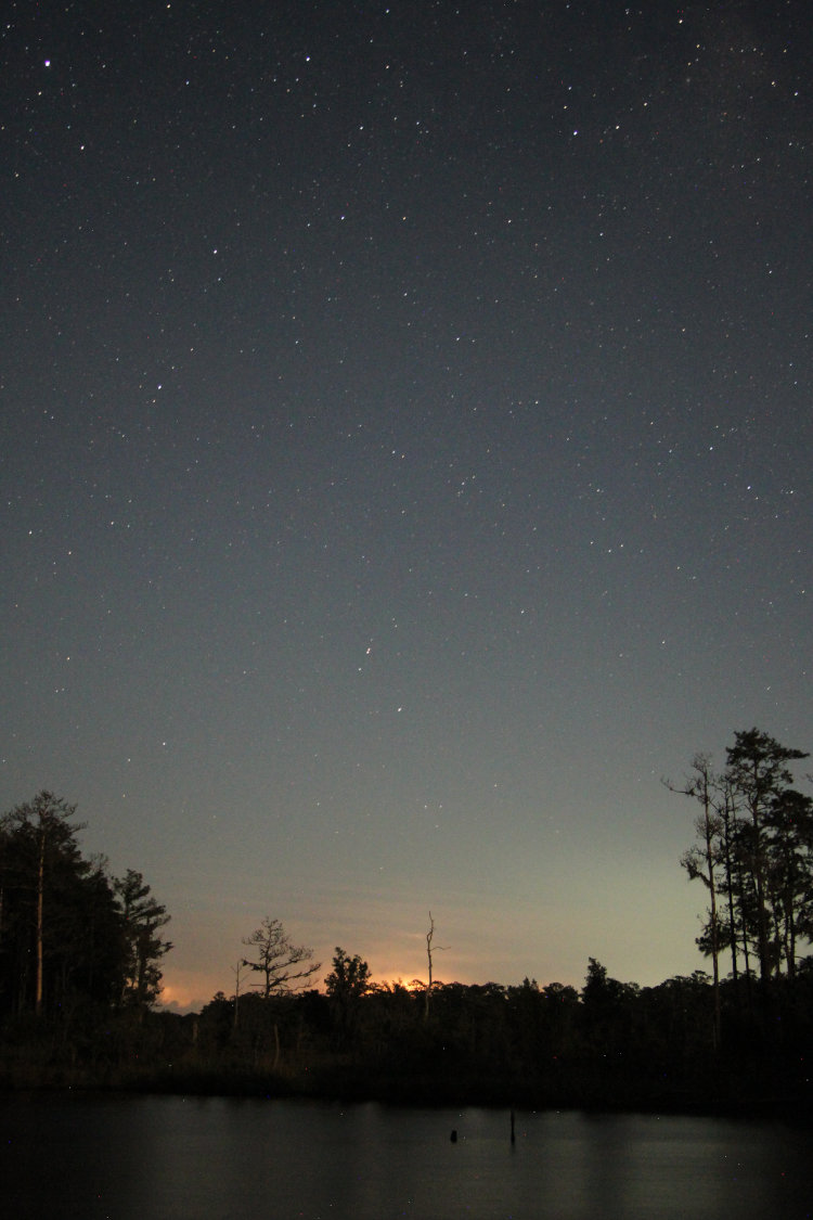 night time exposure of distant storm with clear skies above