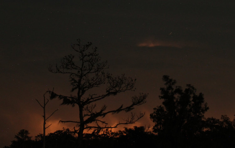 distant thunderstorm activity peeking over the horizon in time exposure at night