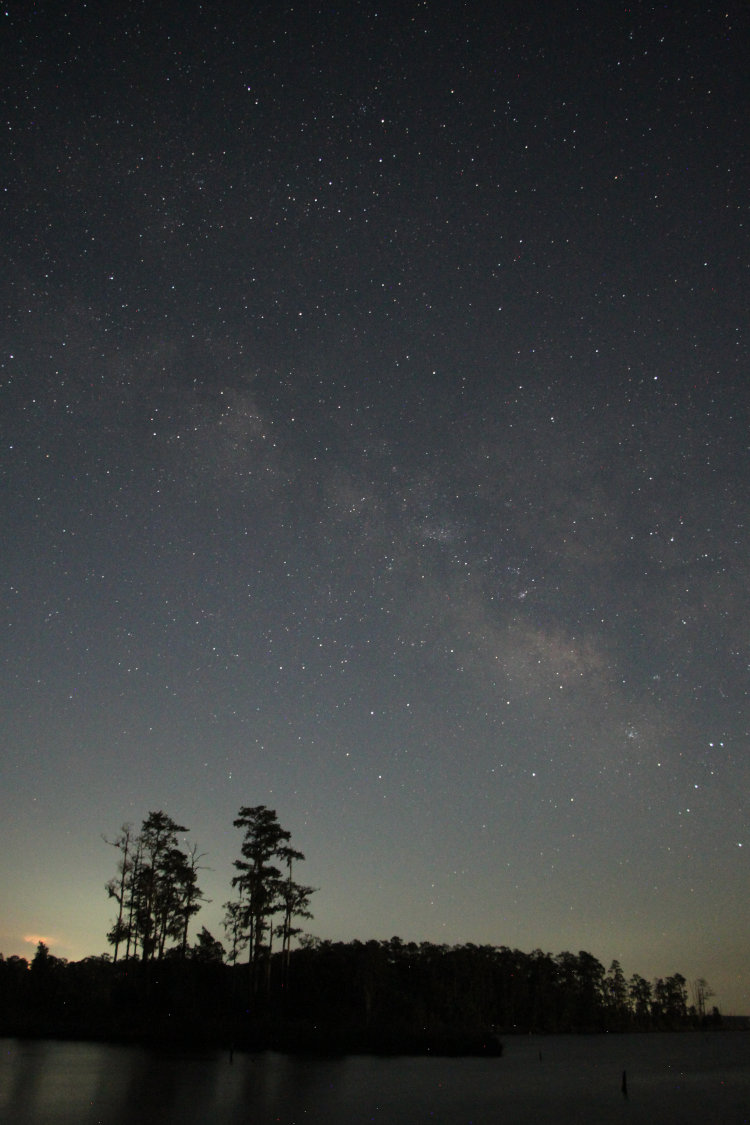 night time exposure showing center of Milky Way and hint of distant thundrestorm