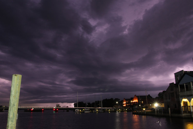 time exposure of thundercells in distance lighting up sky
