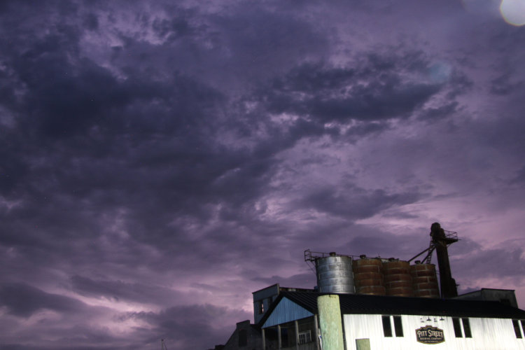 churning clouds lit from within by lightning over Pitt Street Brewing Company