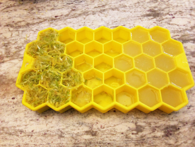 harvest of Key lime Citrus × aurantiifolia zest and juice in ice cube tray for freezing
